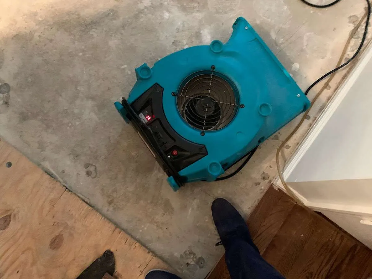 Air mover drying subfloor during Commercial Water Damage Restoration in Natchitoches